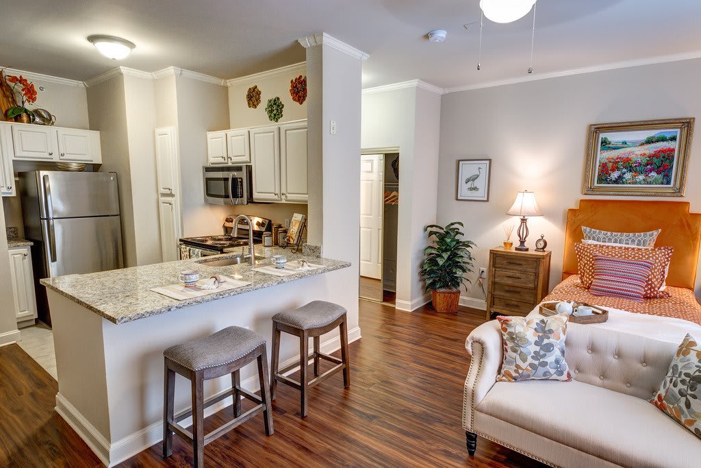 A modern open-concept kitchen and living area with stylish decor and hardwood flooring.