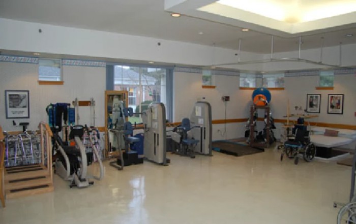A well-equipped indoor gym with various exercise machines and equipment.
