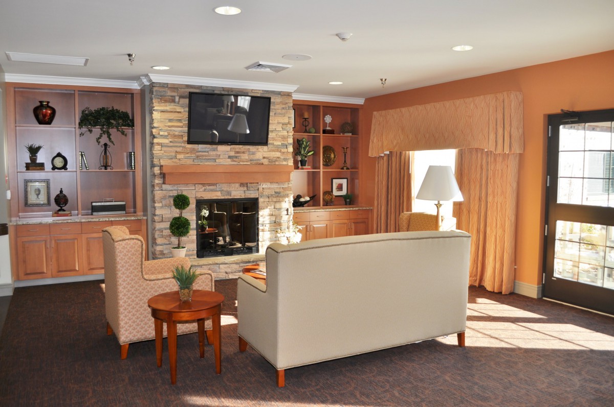 A cozy living room with a fireplace and comfortable seating arrangement.