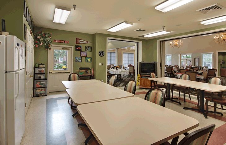 A community meeting room with tables and chairs arranged for gatherings.