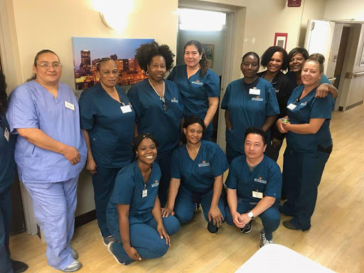 Dedicated healthcare professionals posing together in their scrubs.