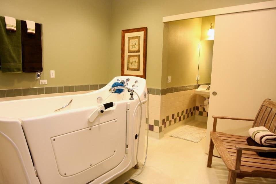 A well-lit bathroom features a walk-in bathtub designed for accessibility.