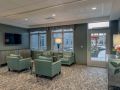 A cozy lobby area with comfortable chairs and a large window view.