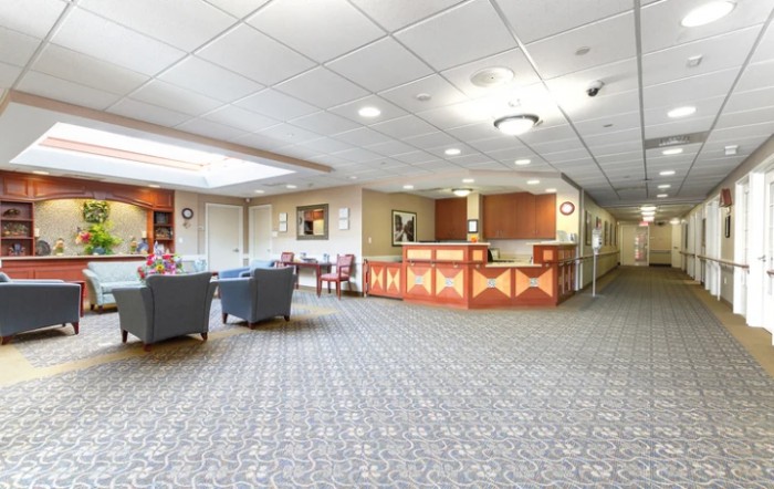 A spacious lobby with a reception desk and seating area.