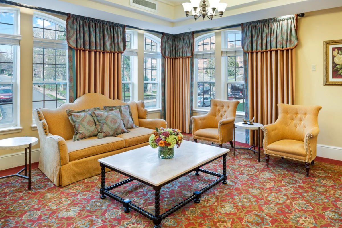 A cozy living room with elegant furnishings and large windows.