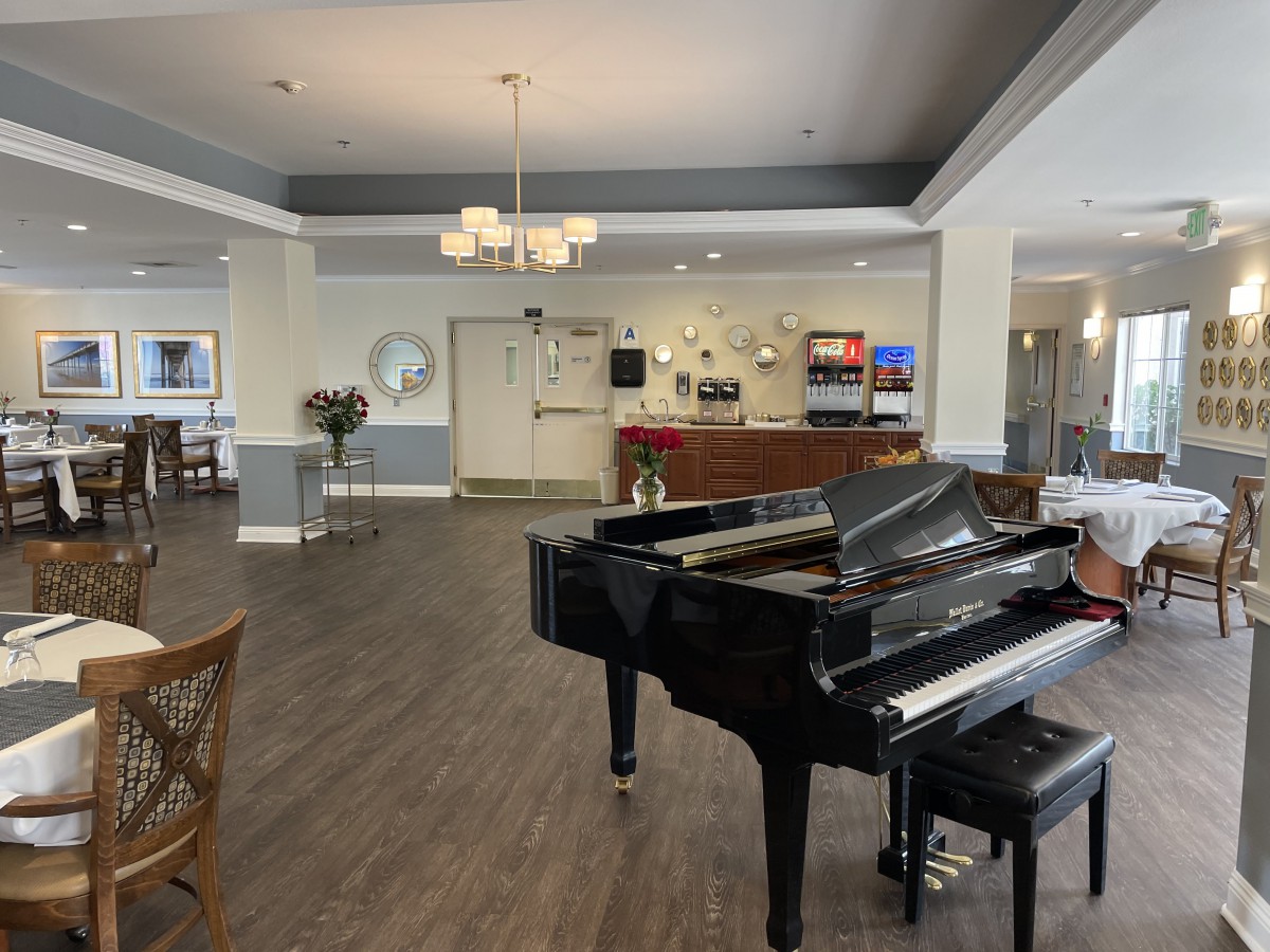 A modern lobby featuring a grand piano and stylish decor.