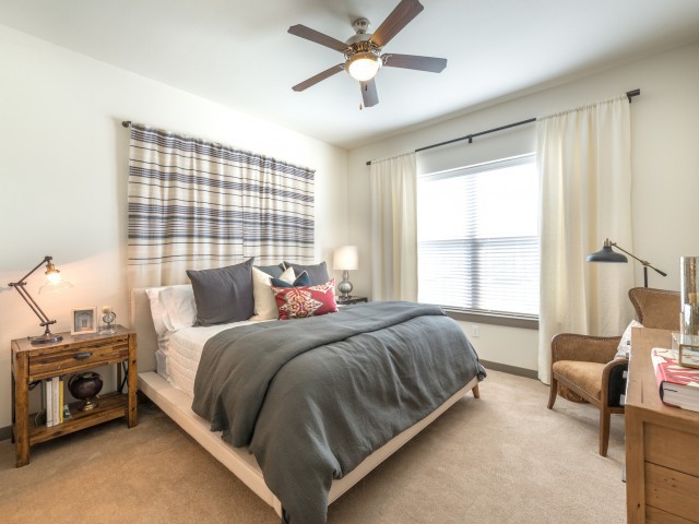 A modern bedroom with a plaid headboard and cozy decor.