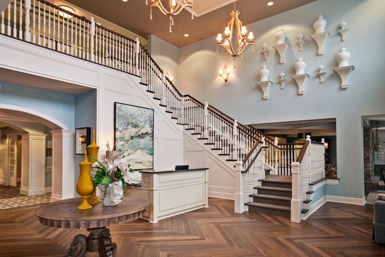 Elegant interior with a grand staircase and chandelier.
