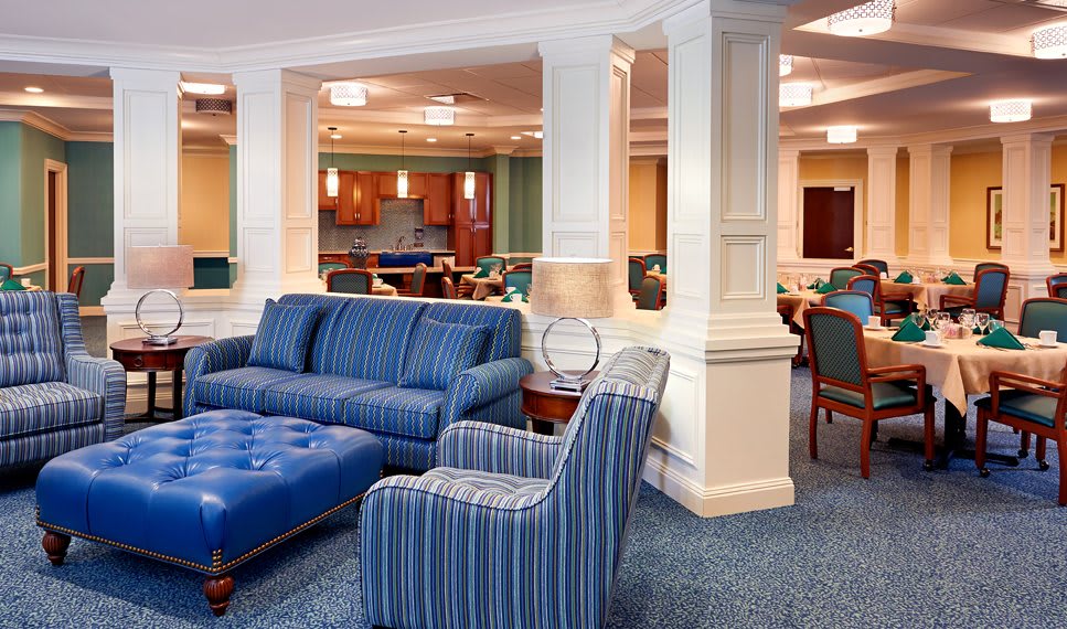 A modern and spacious lounge area with blue upholstered furniture and a comfortable seating arrangement.