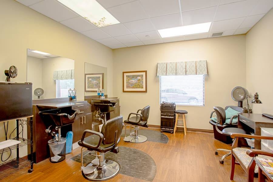 A bright and inviting hair salon interior with styling chairs and mirrors.