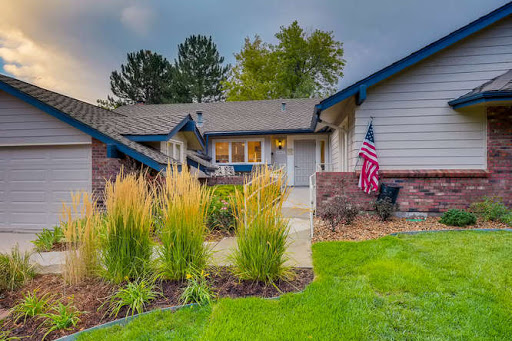 A charming house with well-maintained landscaping and an American flag proudly displayed.