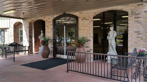 A welcoming entrance featuring decorative statues and planters.