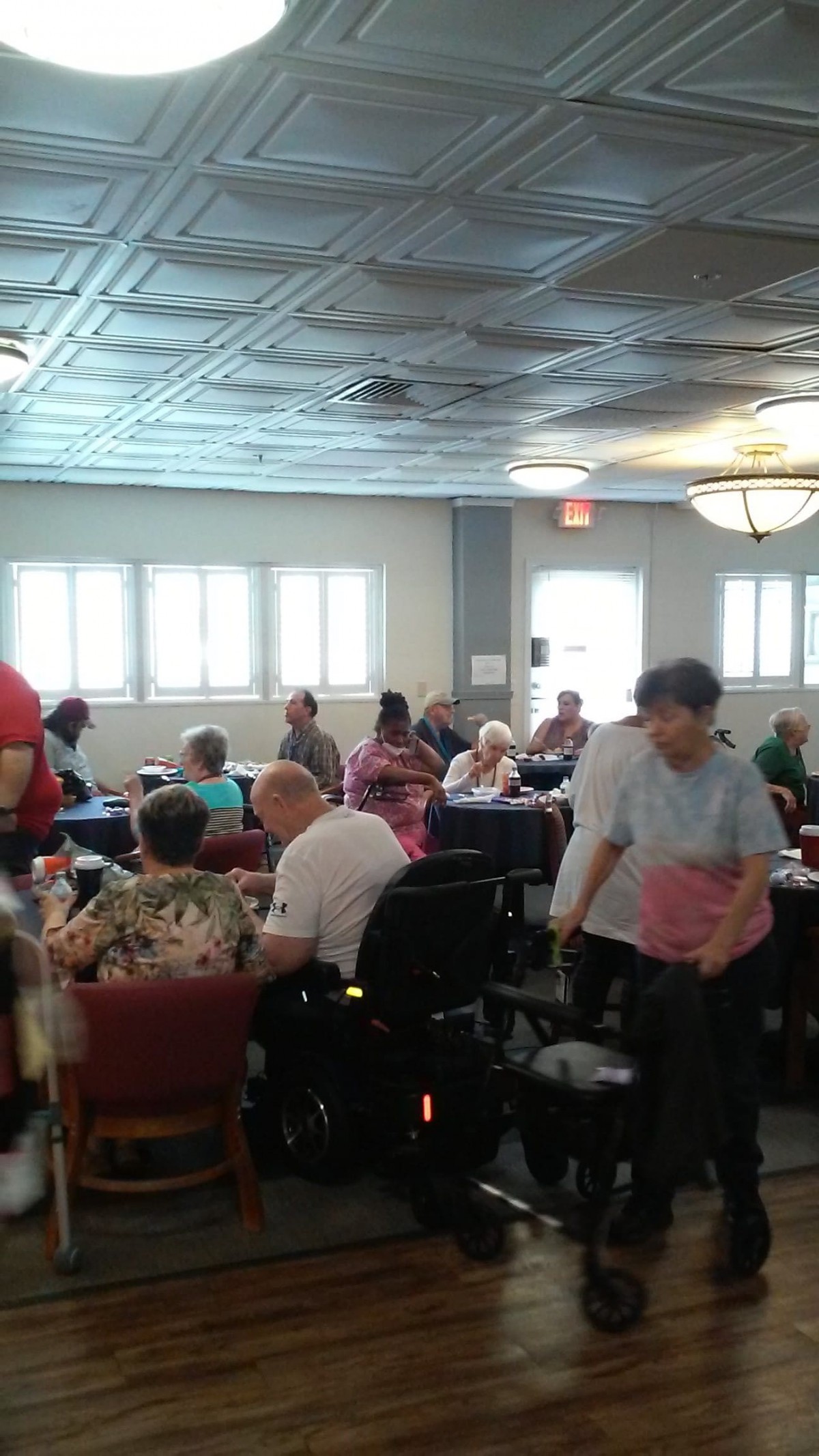 A group of seniors gathered indoors for a social event.
