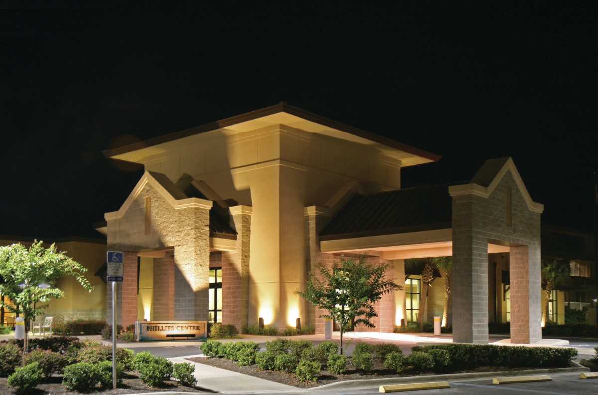 A well-lit building entrance at night showcasing modern architectural design.