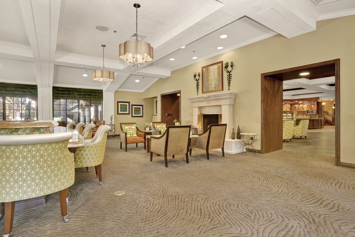 A cozy dining room with elegant seating and a warm fireplace.