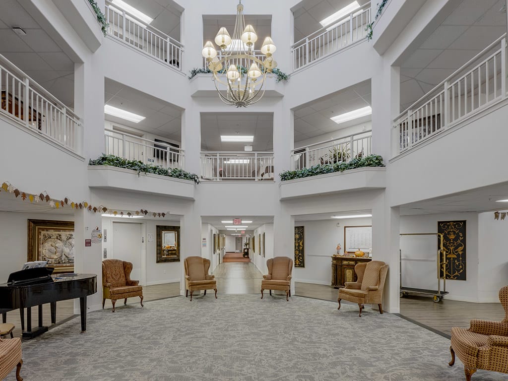 A multi-story atrium with a central chandelier, surrounded by balconies and seating areas.