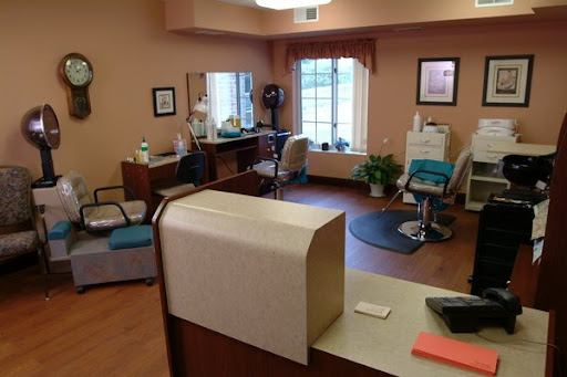 A cozy hair salon interior featuring a reception desk and styling stations.