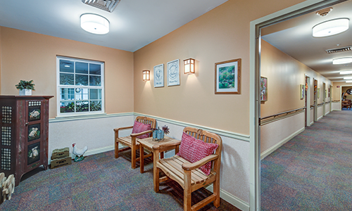 A cozy waiting area with seating and wall decor.