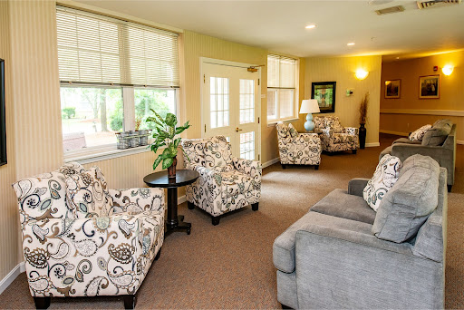A cozy living room featuring comfortable seating and natural light.