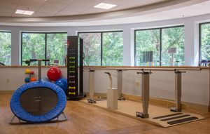 A rehabilitation room equipped with various exercise and therapy equipment.