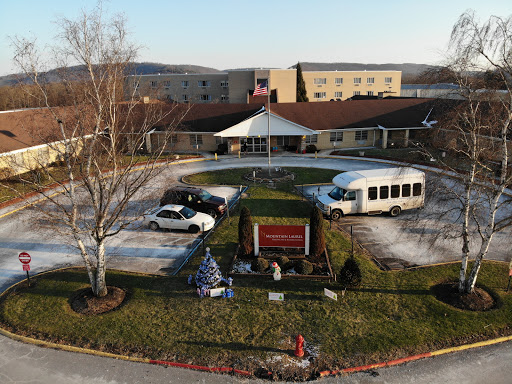 Aerial view of a facility with vehicles parked in front and holiday decorations.