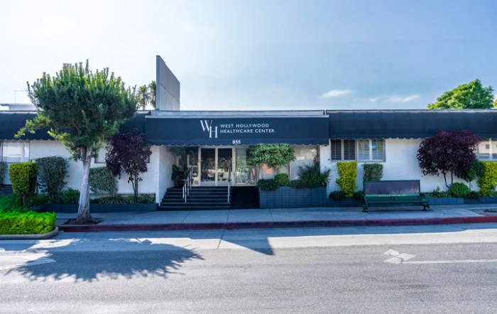 Exterior view of a medical clinic building with signage.