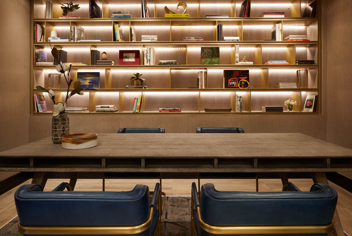A modern library interior with a stylish bookshelf and seating area.