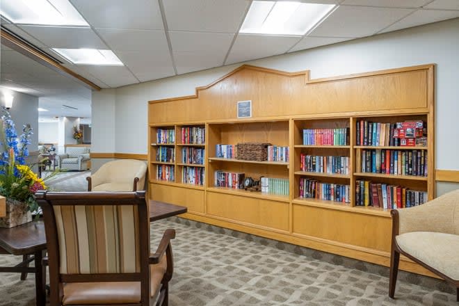 A cozy library reading area with bookshelves and comfortable seating.