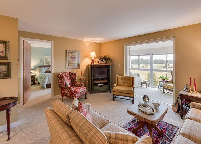 A cozy living room with comfortable seating and large windows offering a view.