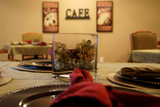 A cozy cafe dining setup with elegant decor and a touch of floral arrangement.