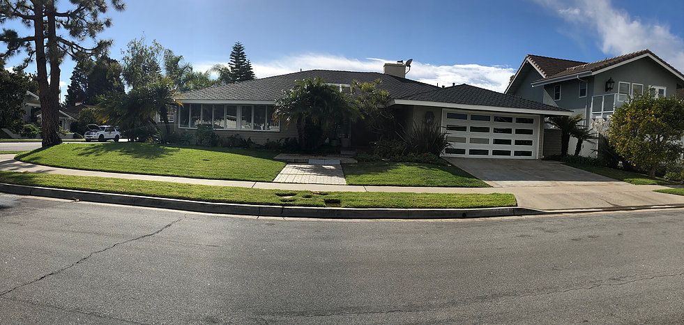 A suburban house with a well-maintained front yard and a two-car garage.