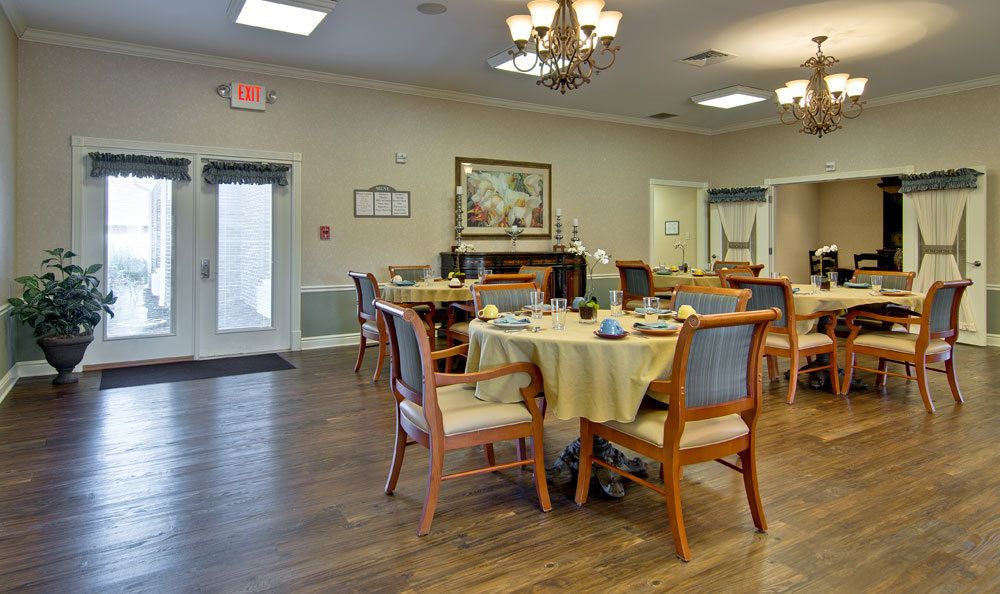 A cozy dining area with well-arranged tables and chairs, adorned with elegant decor.