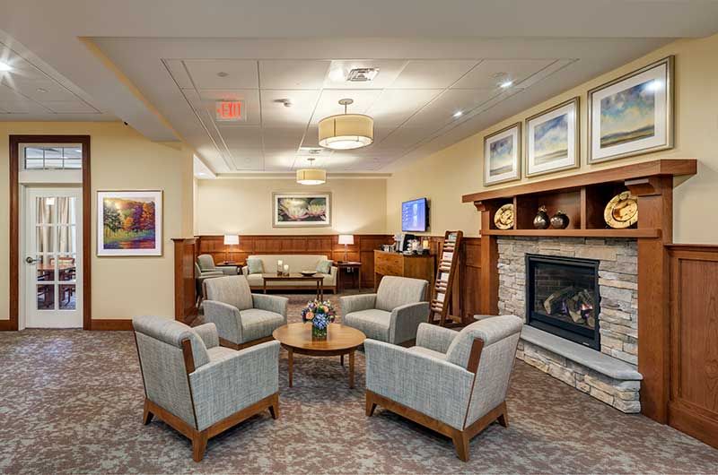 A cozy lounge area featuring a fireplace and comfortable seating arrangements.