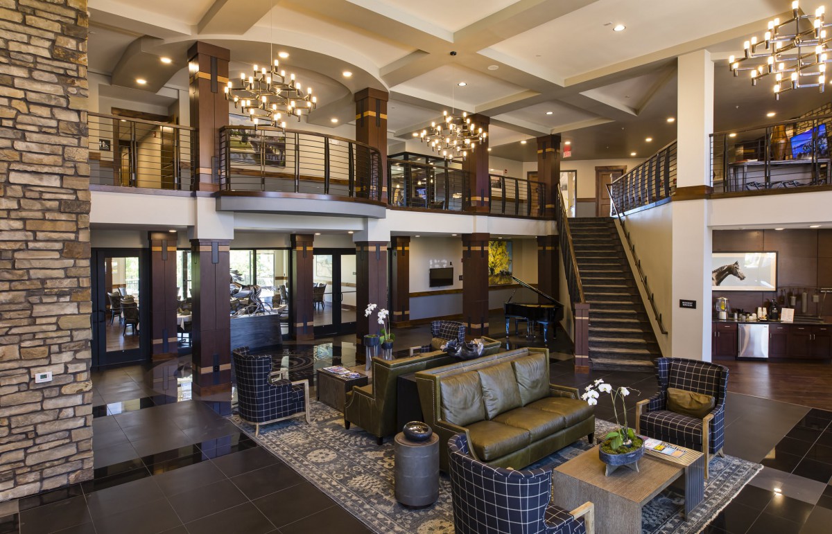 Luxurious modern lobby with elegant furniture and striking chandeliers.