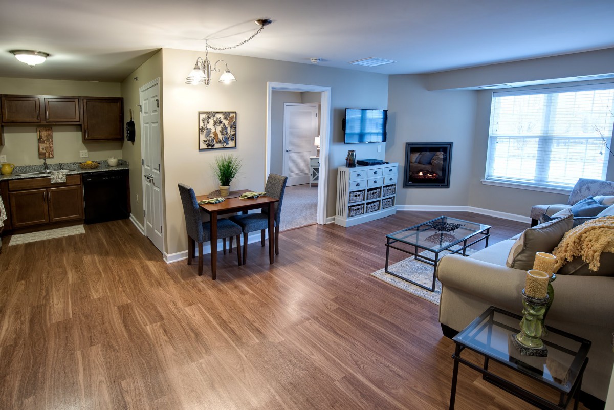 Modern open-concept living and dining area with hardwood floors and stylish furnishings.