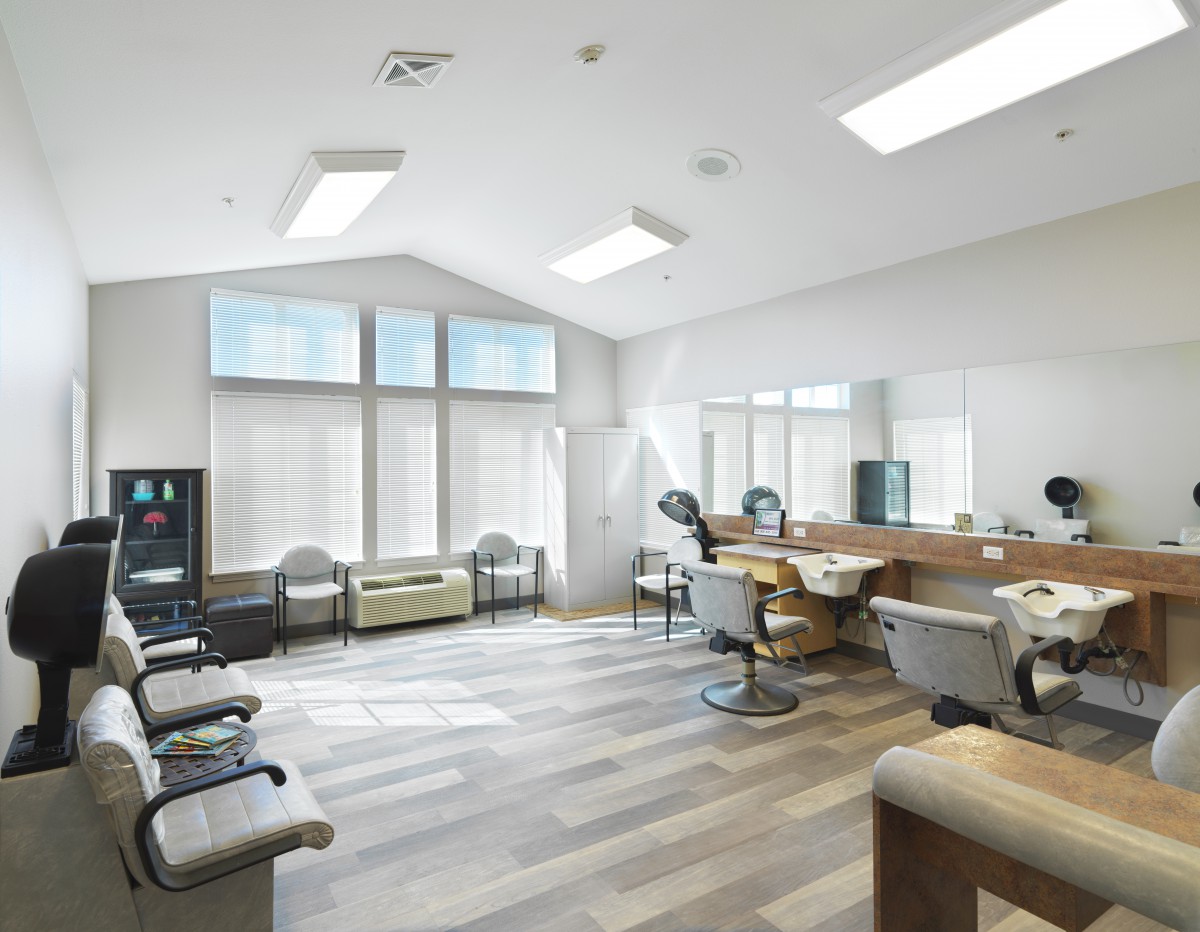 Modern barbershop interior with a spacious waiting area and multiple barber chairs.