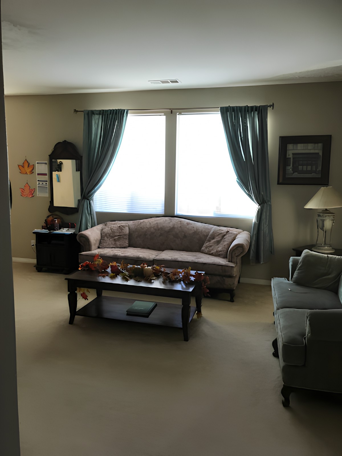 A cozy living room with a sofa, coffee table, and decorative elements.