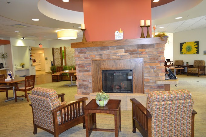 A cozy lounge area with a fireplace and comfortable seating.