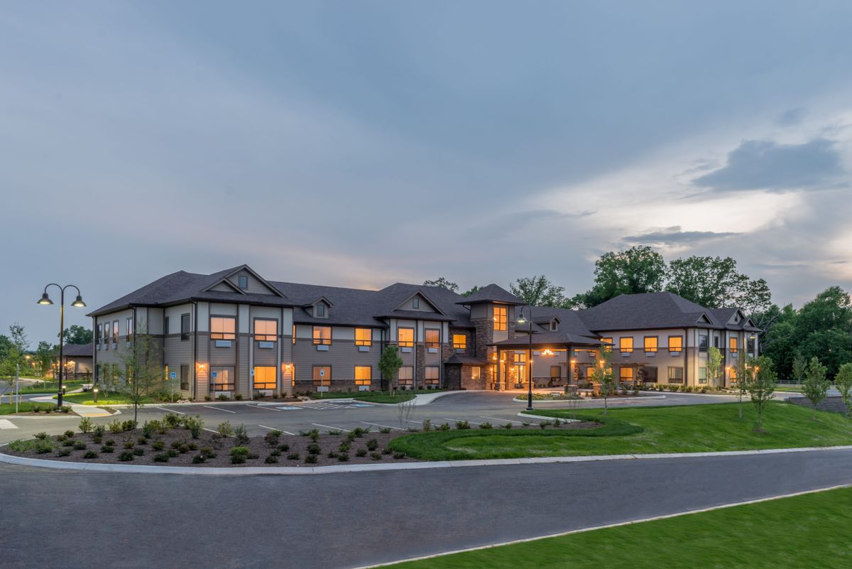 A modern residential house with illuminated windows at twilight.