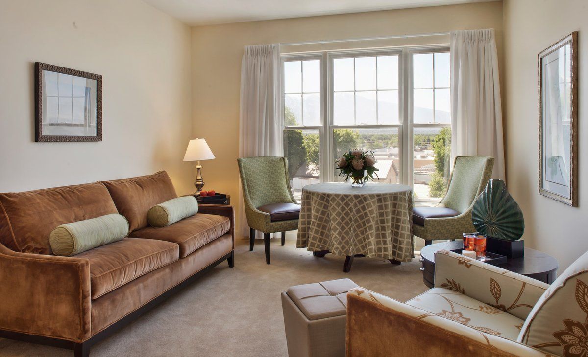 A cozy living room with comfortable seating and a large window providing natural light.