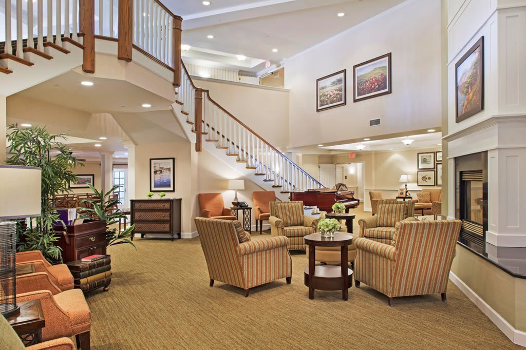 A cozy lobby area with comfortable seating and a grand staircase.