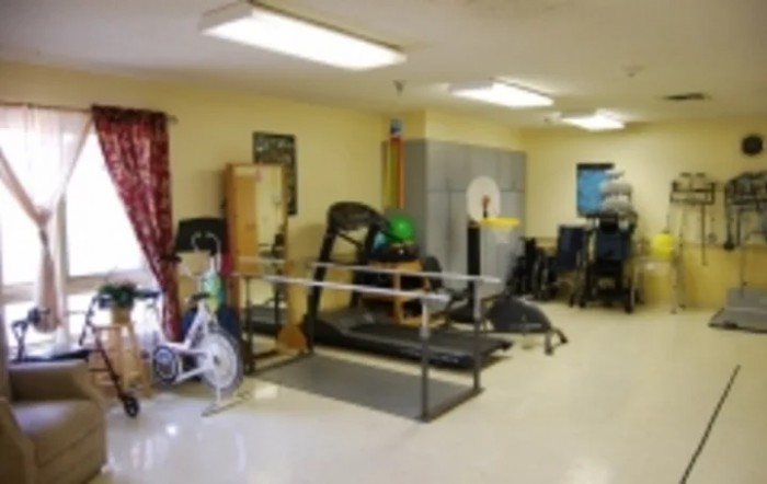 A rehabilitation room equipped with various therapy and exercise equipment.