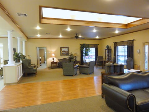 A spacious living room with comfortable seating and large windows.