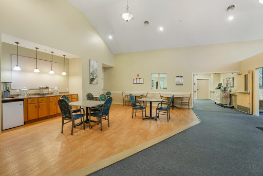 A spacious dining area featuring tables and chairs, ideal for social gatherings or meals.