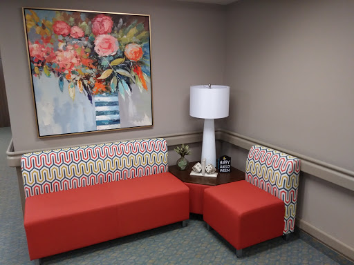 A cozy living space featuring vibrant furniture and a decorative wall art.