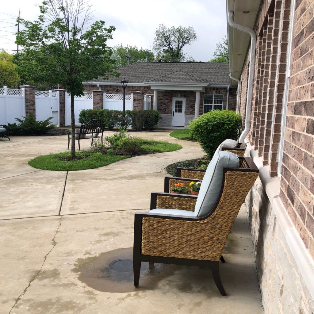 Outdoor chairs in a peaceful courtyard setting.