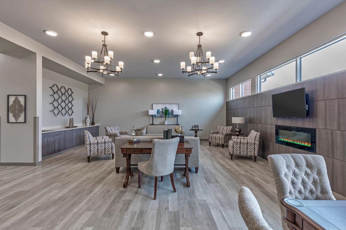 A modern lounge with comfortable seating and elegant chandeliers.