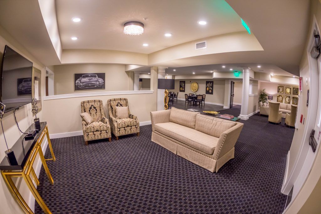A spacious basement living area with comfortable seating and modern decor.