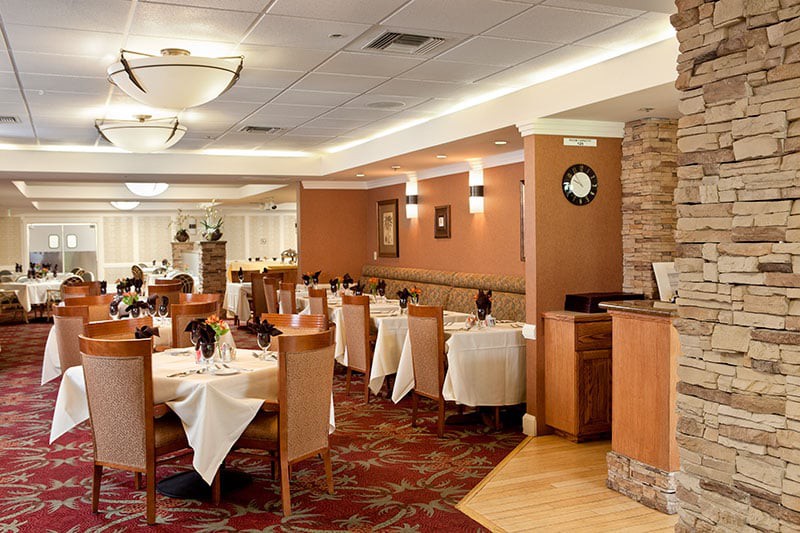 A well-decorated restaurant dining area with neatly arranged tables and chairs.