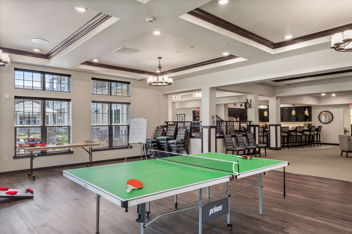 A modern recreation room featuring a ping pong table.